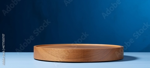Background for products cosmetics, food or jewellery. Round, cylinder shape wood podium on blue background. Front view, Generative AI
