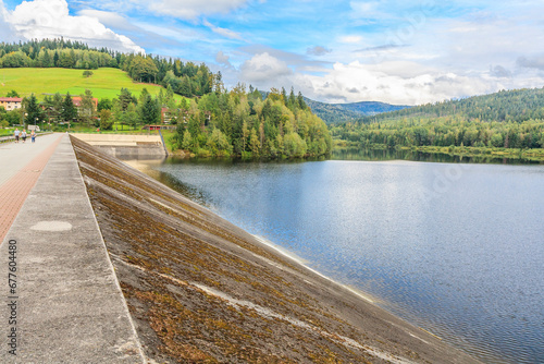 An earthen dam on the Vistula river forming Czerniańskie Lake in the Czarne district in the tourist town - Wisła in the Silesian Beskids (Poland).