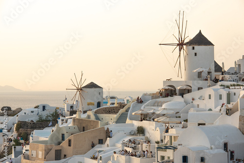 Santorini greek island old town view with white mills and other buildings on sunset. High quality photo