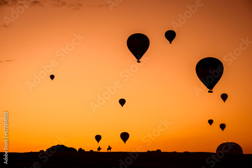 Air balloons at sunset over Cappadocia-Goreme, Turkey, Oct. 20th,2022. A vibrant explosion of light and color, and the enthusiasm of flying an air balloon over the strange rock formation.