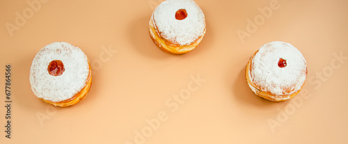 Happy Hanukkah. Traditional Jewish dessert Sufganiyot. Celebrating Judaism holiday. Donuts with jam and sugar powder.