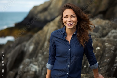 Portrait of a joyful woman in her 30s sporting a versatile denim shirt against a rocky shoreline background. AI Generation