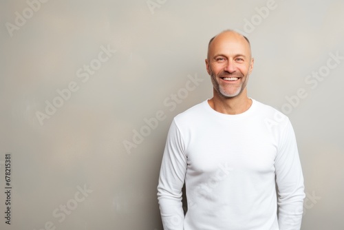 Portrait of a joyful man in his 40s sporting a long-sleeved thermal undershirt against a light wood minimalistic setup. AI Generation