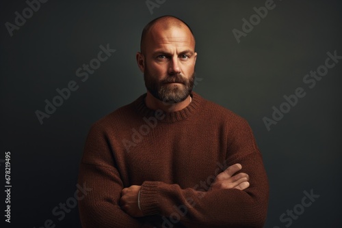 Portrait of a tender man in his 40s dressed in a warm wool sweater against a plain cyclorama studio wall. AI Generation