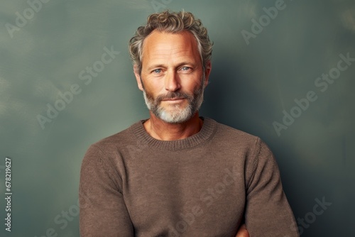 Portrait of a tender man in his 50s wearing a cozy sweater against a plain cyclorama studio wall. AI Generation