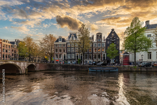 Amsterdam Netherlands, sunset city skyline at canal waterfront