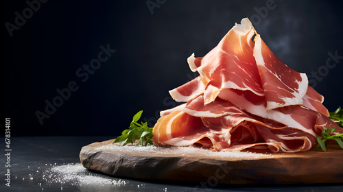 Prosciutto. Stack of Prosciutto ham slices on wooden board on dark background, copy space. Italian charcuteries board with cured meat delicacy on dark Backdrop. Italian appetizer