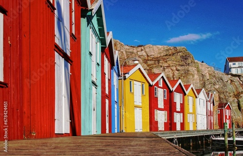 Scenic view of the colorful wooden boathouses lined in the wooden long boardwalk in Smogen, Sweden