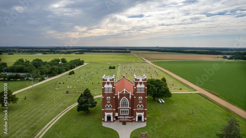 Aerial view of Salemsborg Lutheran Church in a green field near a cemetery in Saline County, Kansas