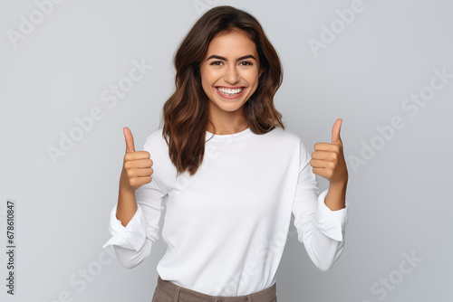 Beautiful brunette woman smiling and showing OK thumb, isolatet background, businesswoman portrait, wearing white shirt