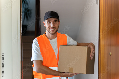 Delivery man delivers package to customer at home. Copy space available.