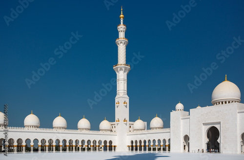 Tall minaret tower of the Sheikh Zayed Grand Mosque built with white marble stone. Abu Dhabi, UAE - 8 February, 2020