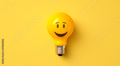 Yellow light bulb with happy face - flat lay. yellow background