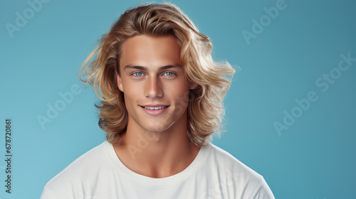 Elegant sexy smiling Caucasian blond man with blond and long hair with perfect skin, on a light blue background, banner.