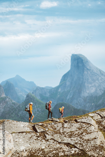 Family hiking expedition in mountains active vacations, parents and child traveling in Norway outdoor adventure tour healthy lifestyle, mother and father mountaineering together with kid in Lofoten