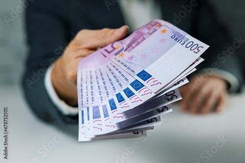 hand give 500 euro banknotes. bank money loan, consumer credit and quick loans concept