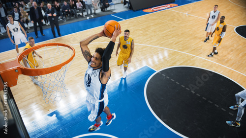 Cinematic College Basketball Tournament: Two Young Successful Diverse Teams Play a Championship Match in a Modern Arena. Excited African Player Scores a Perfect Slam Dunk with Two Hands.