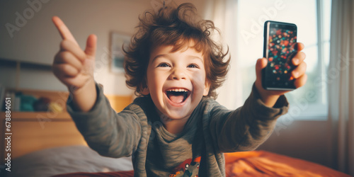 Happy little child with smartphone sitting indoors.