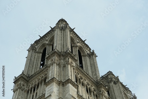 Low angle shot of Cathedral Notre-Dame de Paris under blue sky in France