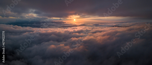 Panorama shot of colorful light of sunrise over rainforest mountains with fog and cloud inversion for natural cinematic of national park and wildlife reserve area