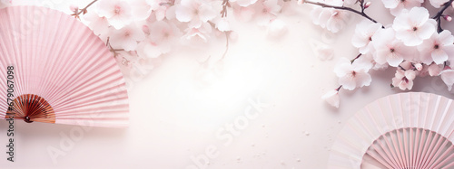Traditional Japanese fan sensu in pink sakura blossom, spring banner background