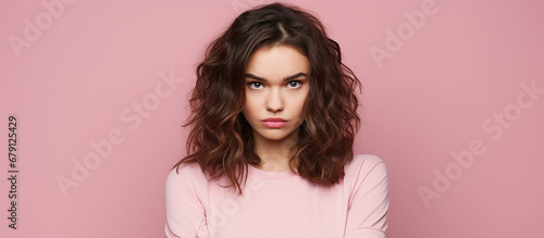 Photo of unhappy young woman bad mood irritated problem raise eyebrow isolated on pink color background. Made with generative ai