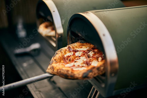 Close-up of a freshly baked pizza, getting right from the oven.