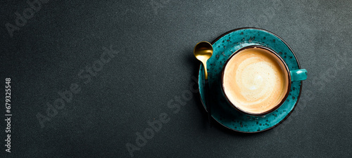 A cup of cappuccino and coffee beans. Top view, on a black background, free copy space. Robusta or Arabica.