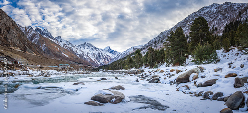 Serene Landscape of frozen Baspa river valley near Chitkul village in Kinnaur district of Himachal Pradesh, India. It is the last inhabited village near the Indo-China border.