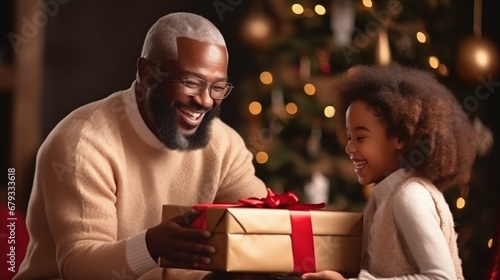 African American father presenting a gift to a girl