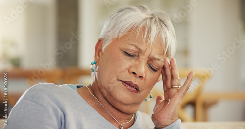 Headache, senior woman and stress in home for retirement, mental health and anxiety of brain fog. Face, sad and frustrated elderly lady with migraine, crisis and pain of vertigo, trauma and fatigue