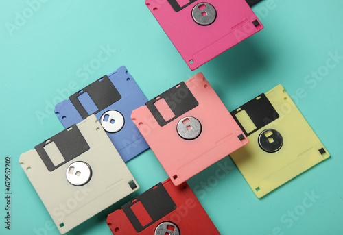 Floating colored retro 80s floppy disks on a blue background. Conceptual pop, creative layout