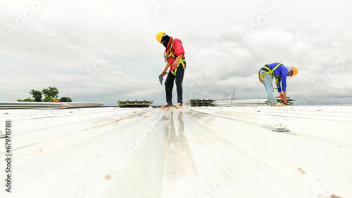  Construction worker install roof, Roofing tools, worke using Electric drill replacement install roof roof plates.