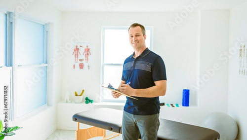 Modern rehabilitation physiotherapy man holding notepad