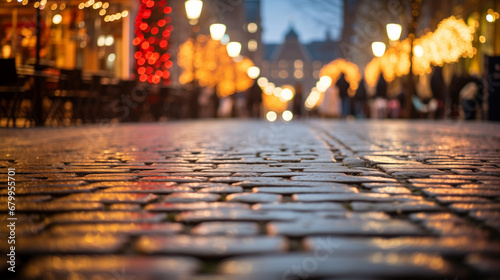 Christmas market glows in the night city, blurred background, focus on paving stones