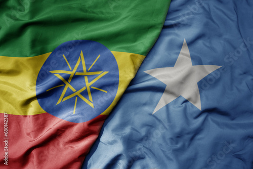 big waving national colorful flag of somalia and national flag of ethiopia .