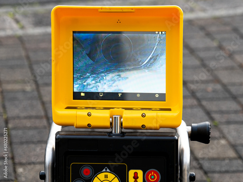A drain cleaning company checks a blocked drain with a camera before flushing it out. Screen shows the cleaning process of the blocked pipe.