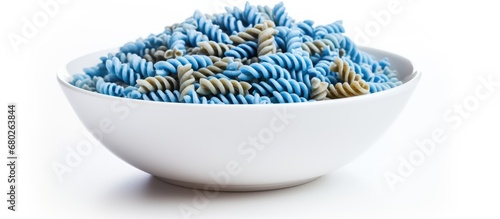 The closeup shot of a blue spiral-shaped fusilli pasta in a white bowl showcases the organic and wholemeal nature of this biodynamic Italian food, emphasizing its nutritious value and rich