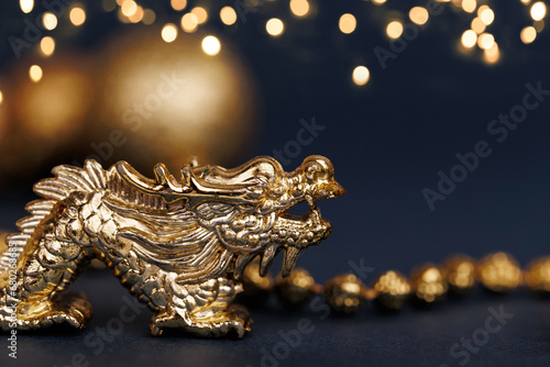 Golden dragon symbol of the year 2024 on a dark background