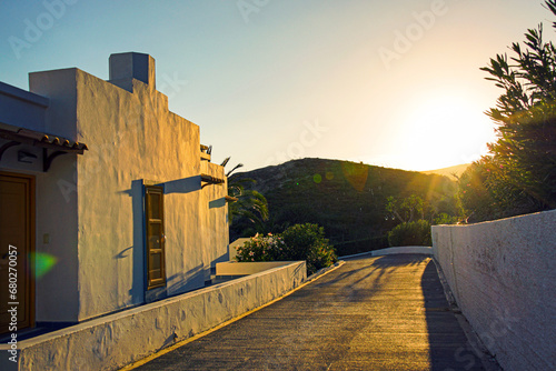 impressive sunset over hills with typical white greek houses in the foreground