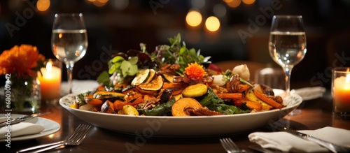 In the cozy, dimly lit restaurant, a white table was adorned with a beautiful spread of autumn-inspired dishes - the vibrant orange of roasted vegetables, the rich black of a truffle-infused sauce