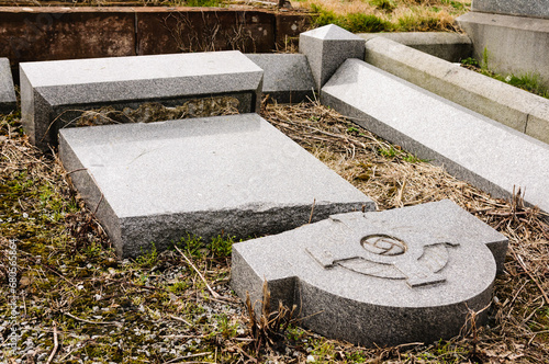 Broken gravestone in a cemetery after it has been vandalised