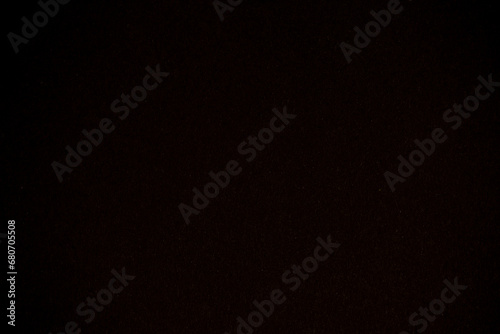 Detail of black colour paper sheet (school poster board, bristol board) texture. Plain background