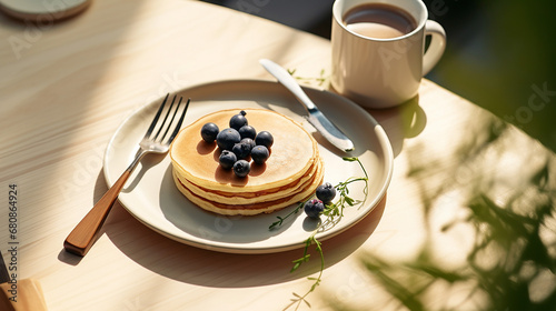 pancake blueberry black raspberry in white ceramic plate fork with space in sunlight