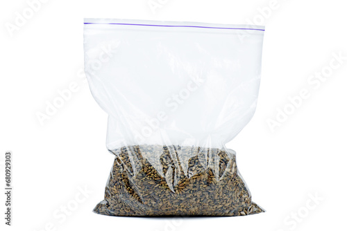 Seeds of a Milk Thistle (Silybum marianum) in plastic bag isolated on a white background