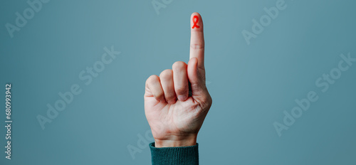 finger with red ribbon for the fight against AIDS