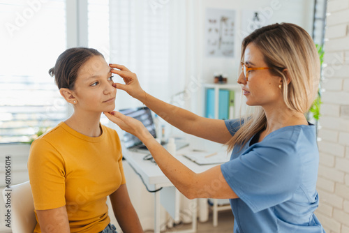 Pediatrician examining eyes of a teenage patient.The ophthalmologist treating an eye infection, allergy, or inflammation in ophthalmic clinic.