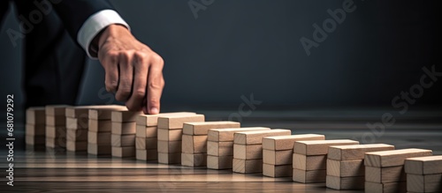 Outlined businessman halts domino effect on gray background Copy space image Place for adding text or design