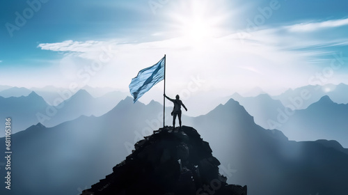 Silhouette of man holding blue flag on top of mountain, achievement and success concept