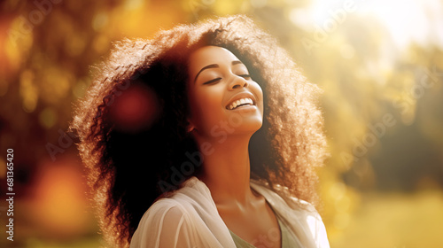 YOUNG AFRICAN AMERICAN WOMAN ENJOYING THE FEELING OF FREEDOM IN NATURE ON A SUNNY DAY. legal AI 